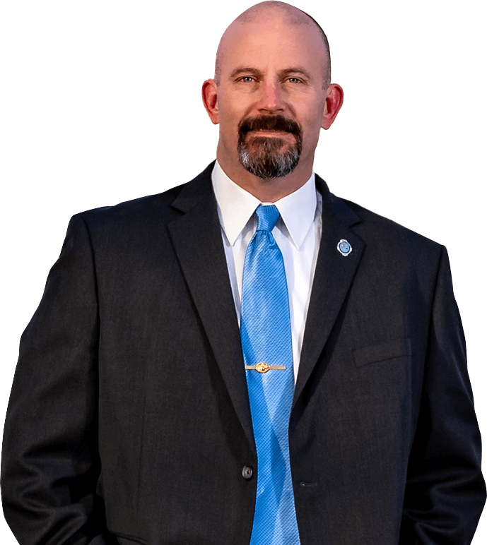 Chris Lee in smiling in a suit and blue tie